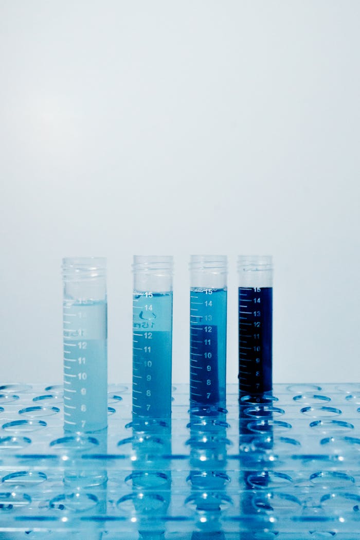 Close-up of test tubes with colorful liquids in a laboratory setting.